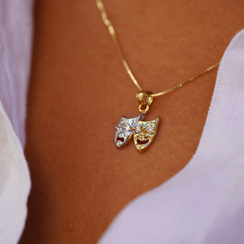 Model wearing 14K Two-Tone Solid Gold Comedy & Tragedy Charm from the right angle, highlighting cubic zirconia accents and two-tone gold design.