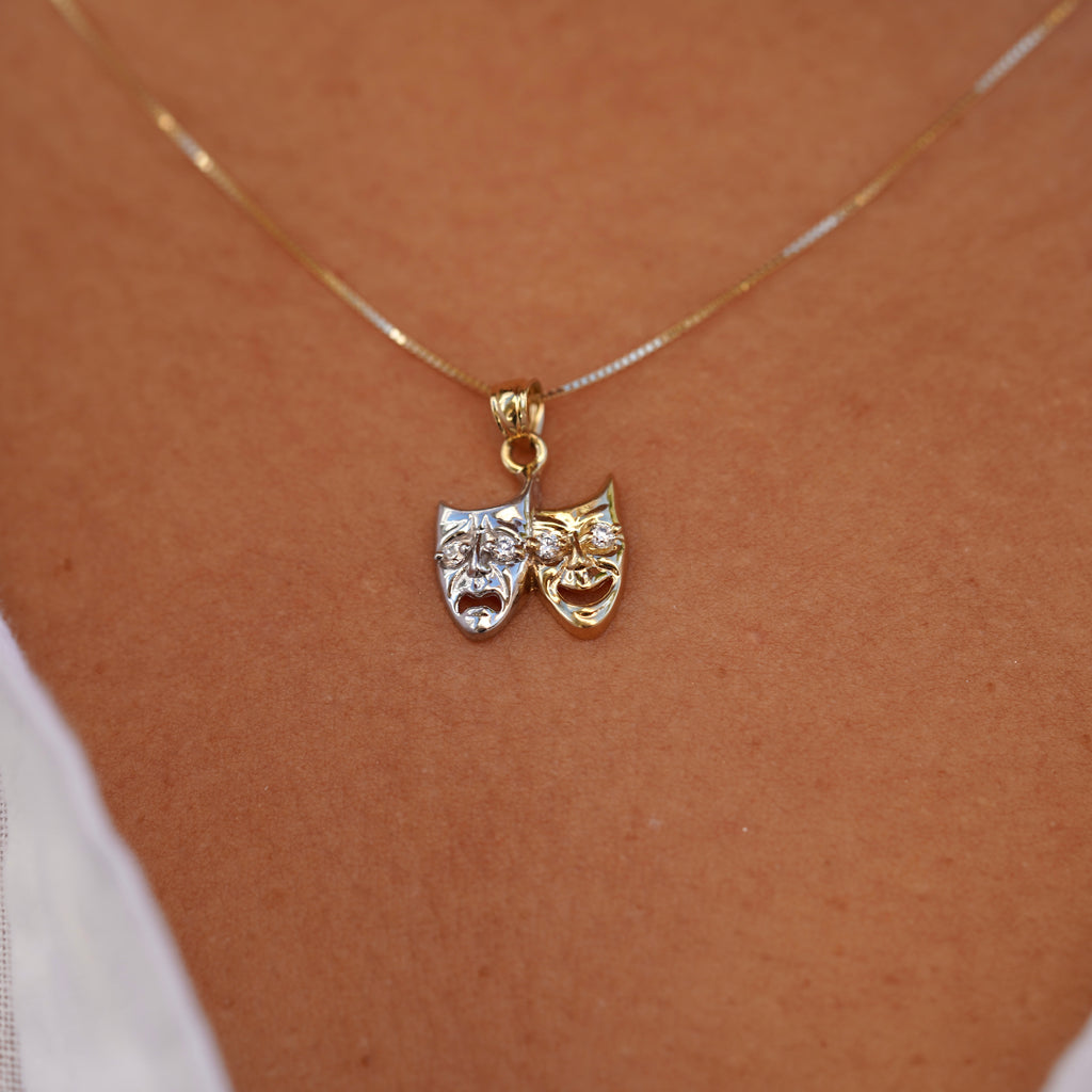 Model wearing 14K Two-Tone Solid Gold Comedy & Tragedy Charm, showcasing the theater mask design with cubic zirconia in white and yellow gold.