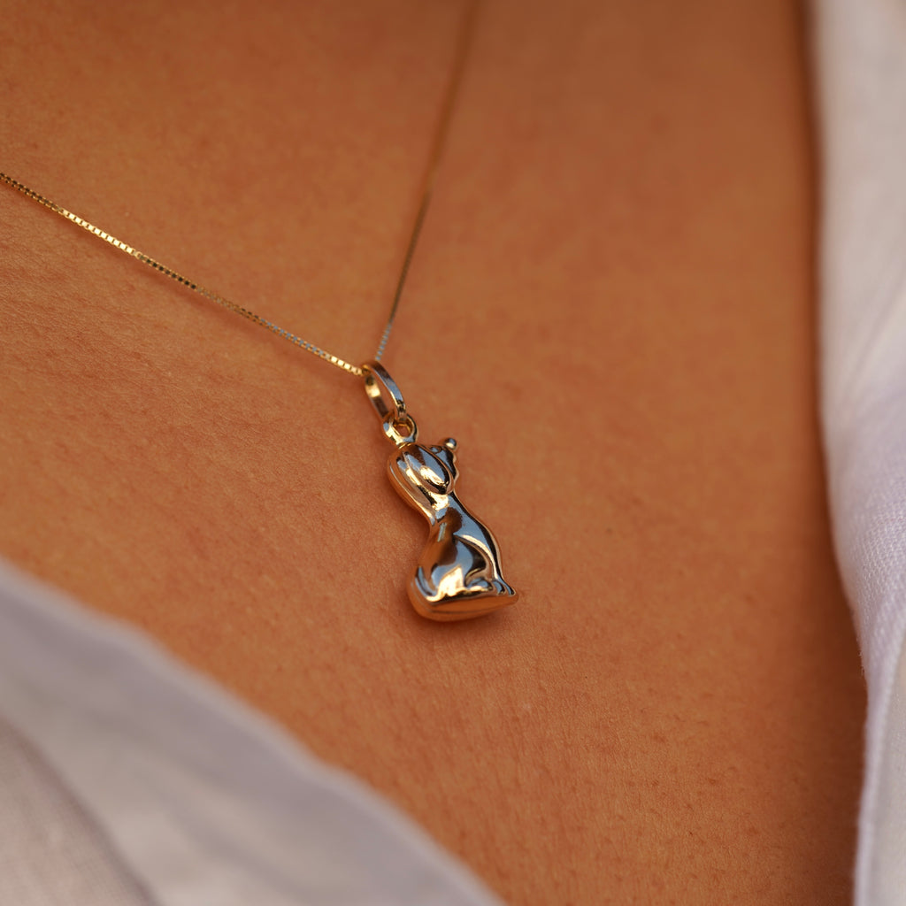 Model wearing the 14K Gold Dog Charm Pendant on a necklace, highlighting its polished finish and elegant canine design.