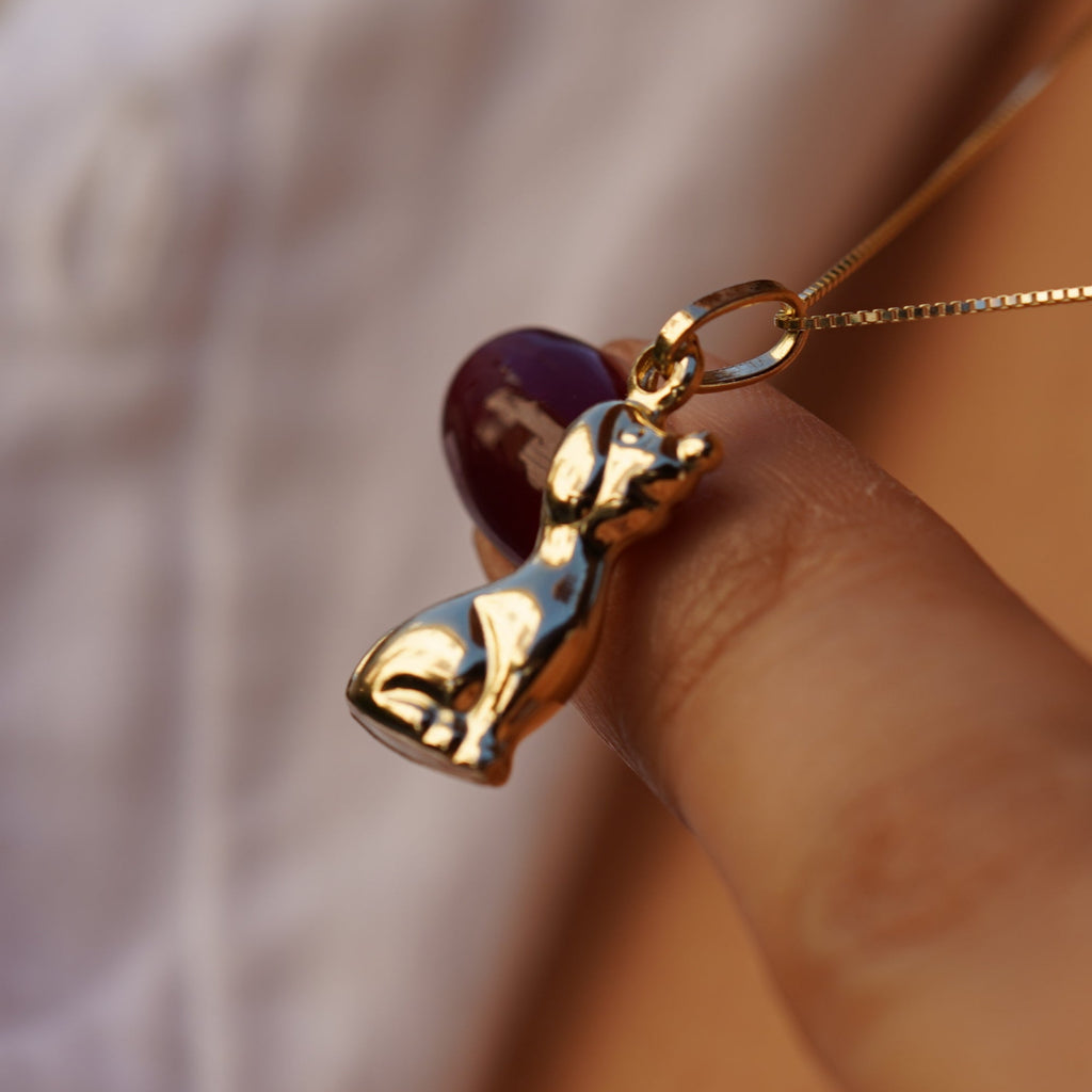 Model wearing the 14K Gold Dog Charm Pendant on a necklace, highlighting its polished finish and elegant canine design.