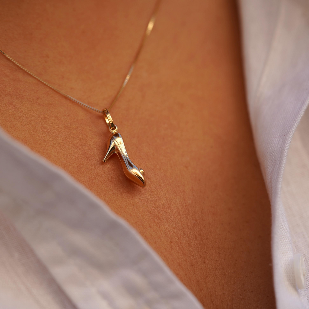 Model wearing the 14K Gold Heel Shoe Charm Pendant on a chain, highlighting its elegant high heel design and delicate gold craftsmanship.
