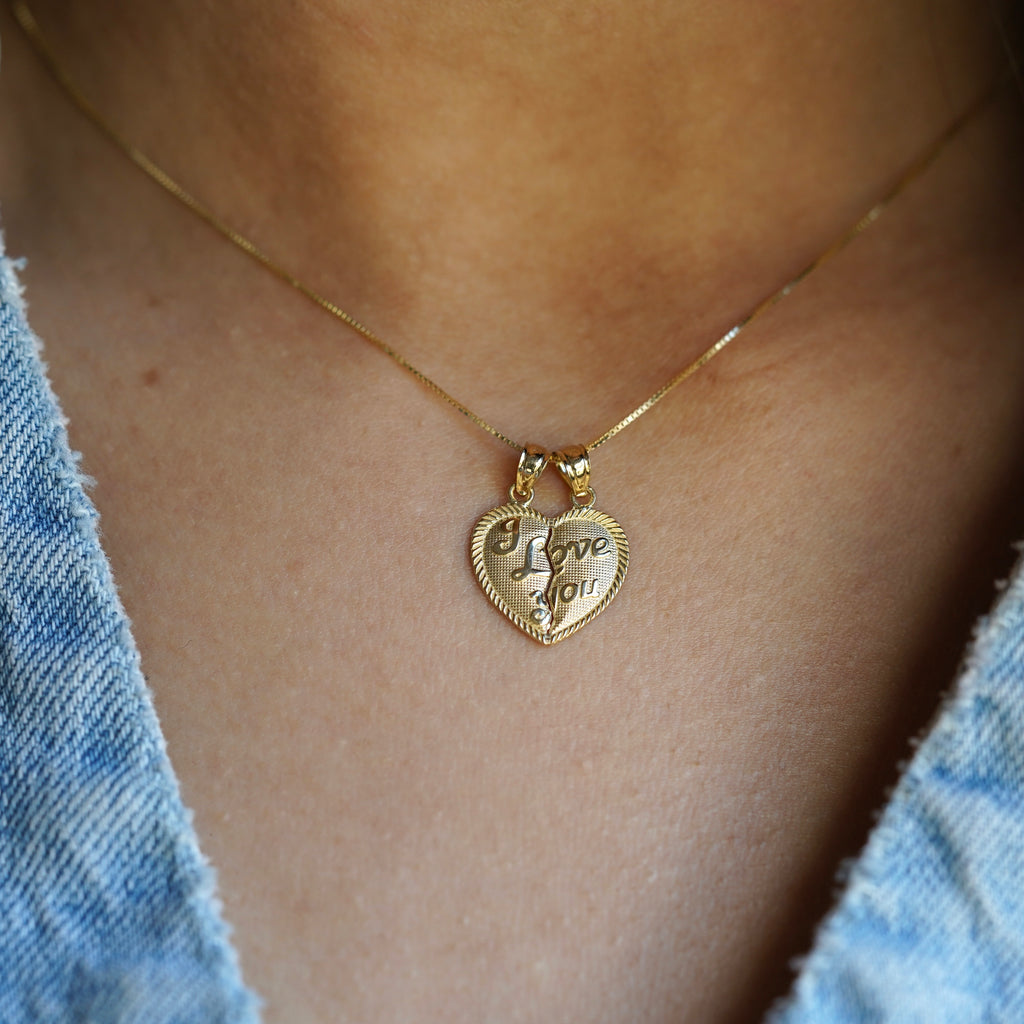 Model wearing the 14K Solid Gold 'I Love You' Breakable Heart Pendant as a necklace, shown from a front-facing angle to highlight its polished surface and elegant design.