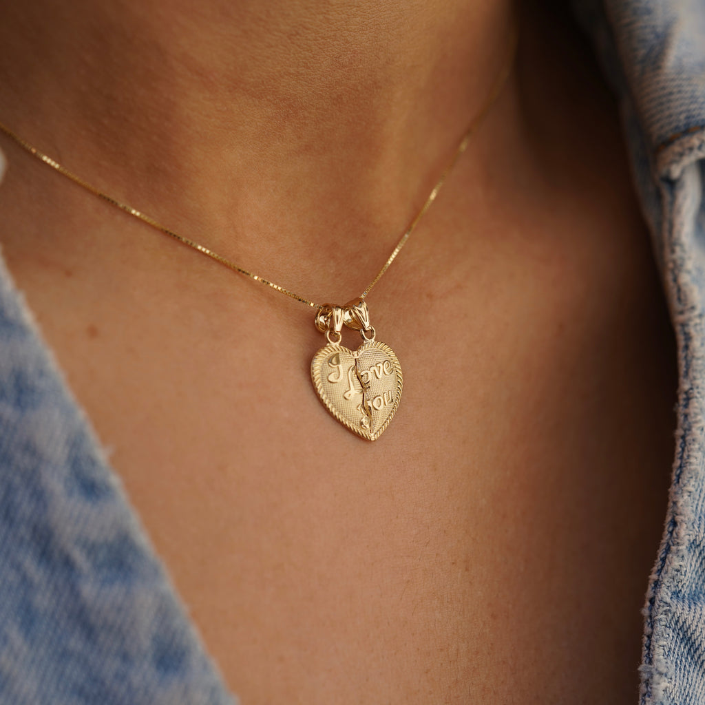 Model showcasing the 14K Solid Gold 'I Love You' Breakable Heart Pendant from a side angle, emphasizing its unique heart shape and romantic appeal.