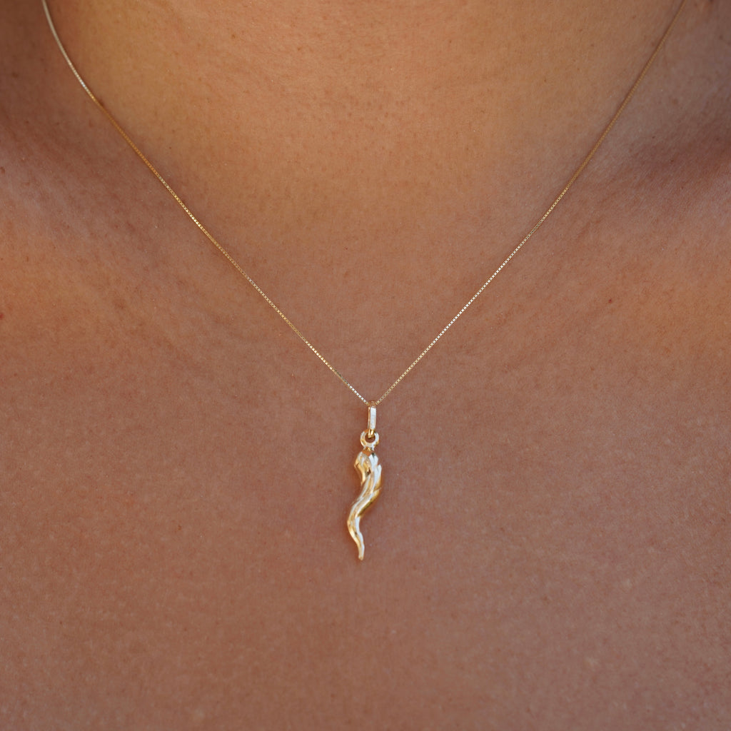 14K Real Gold Twisted Cornicello Italian Horn Charm worn by a model, front view.