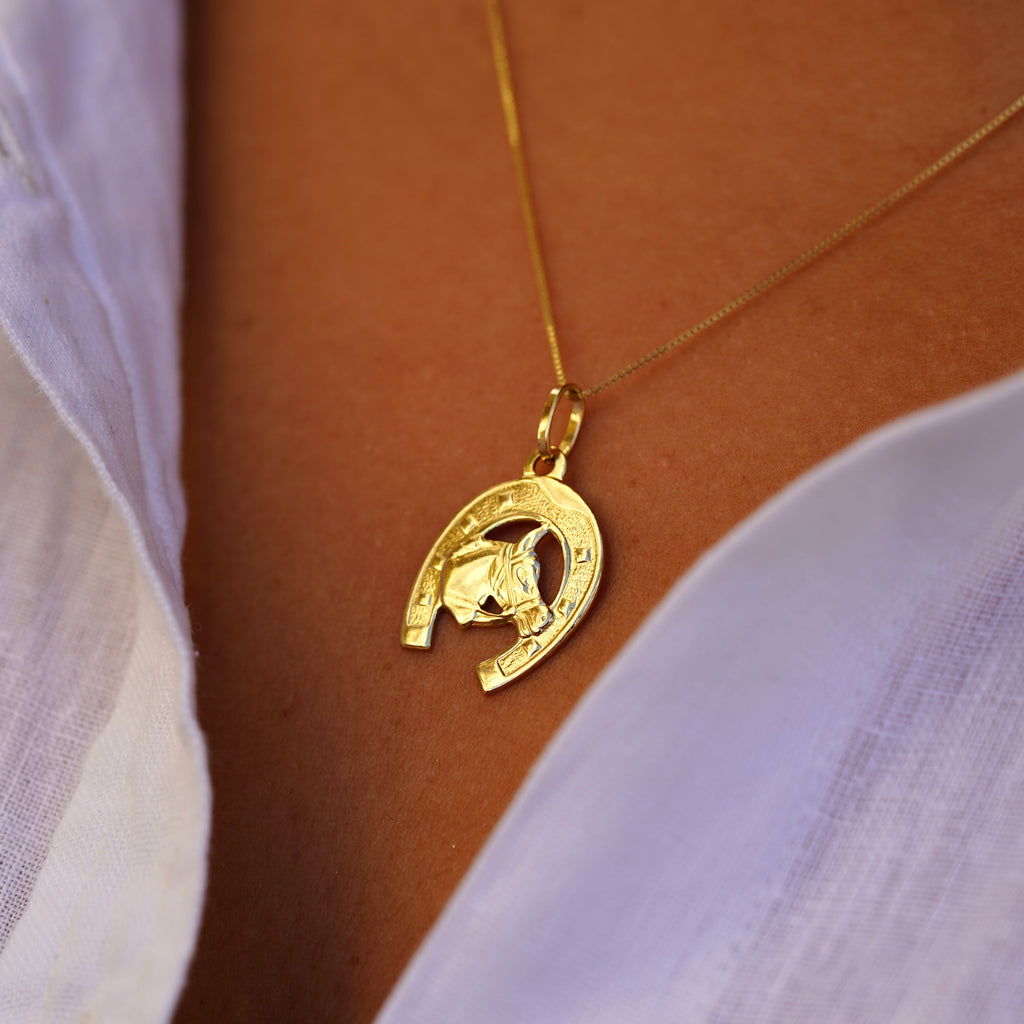 Right side view of a model wearing the 14K Solid Gold Horse with Horseshoe Pendant, highlighting the charm’s craftsmanship and gold shine from the side.