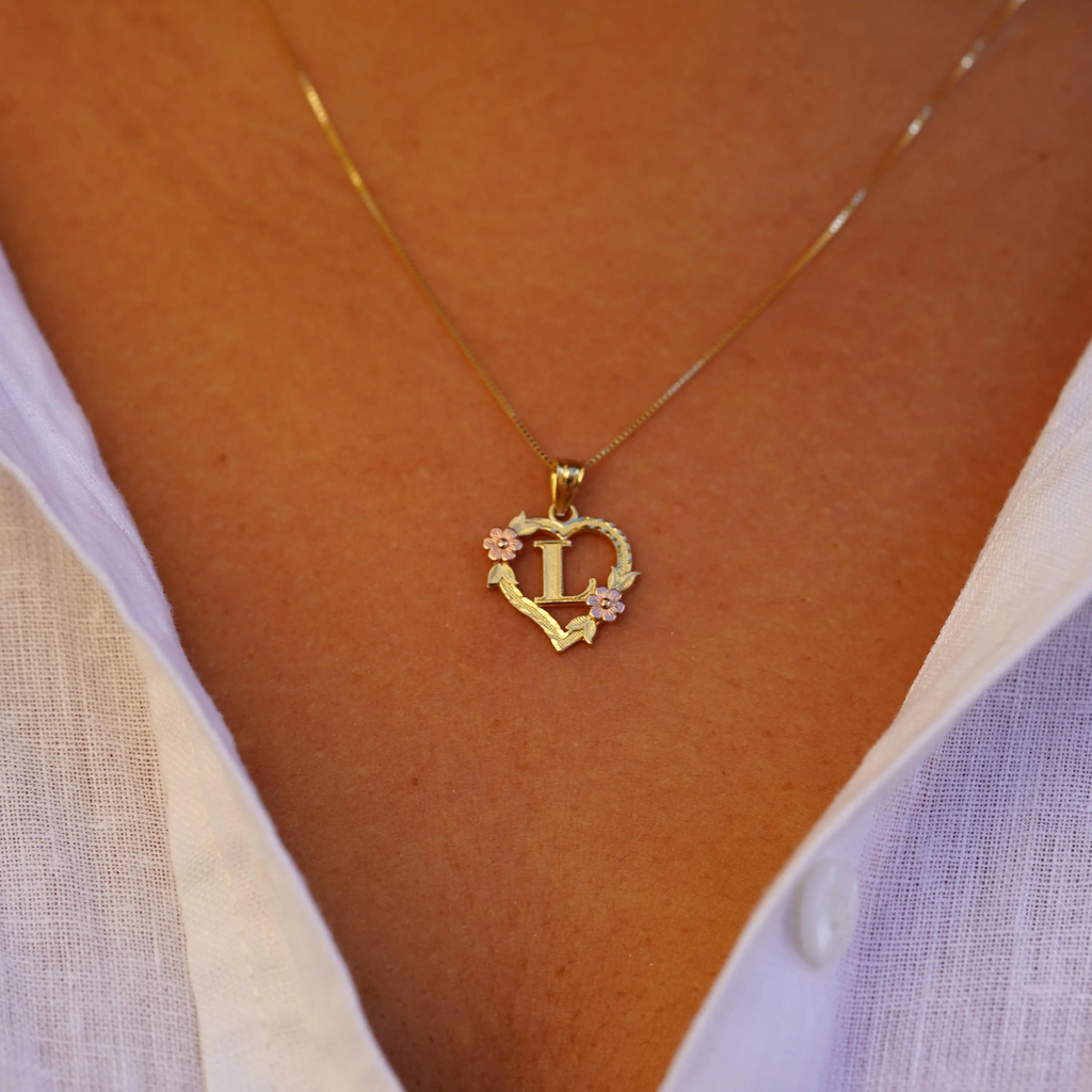 Model wearing the 14K Two-Tone Initial Heart Pendant with Letter L, displaying the heart charm from the front with its blend of yellow and rose gold.