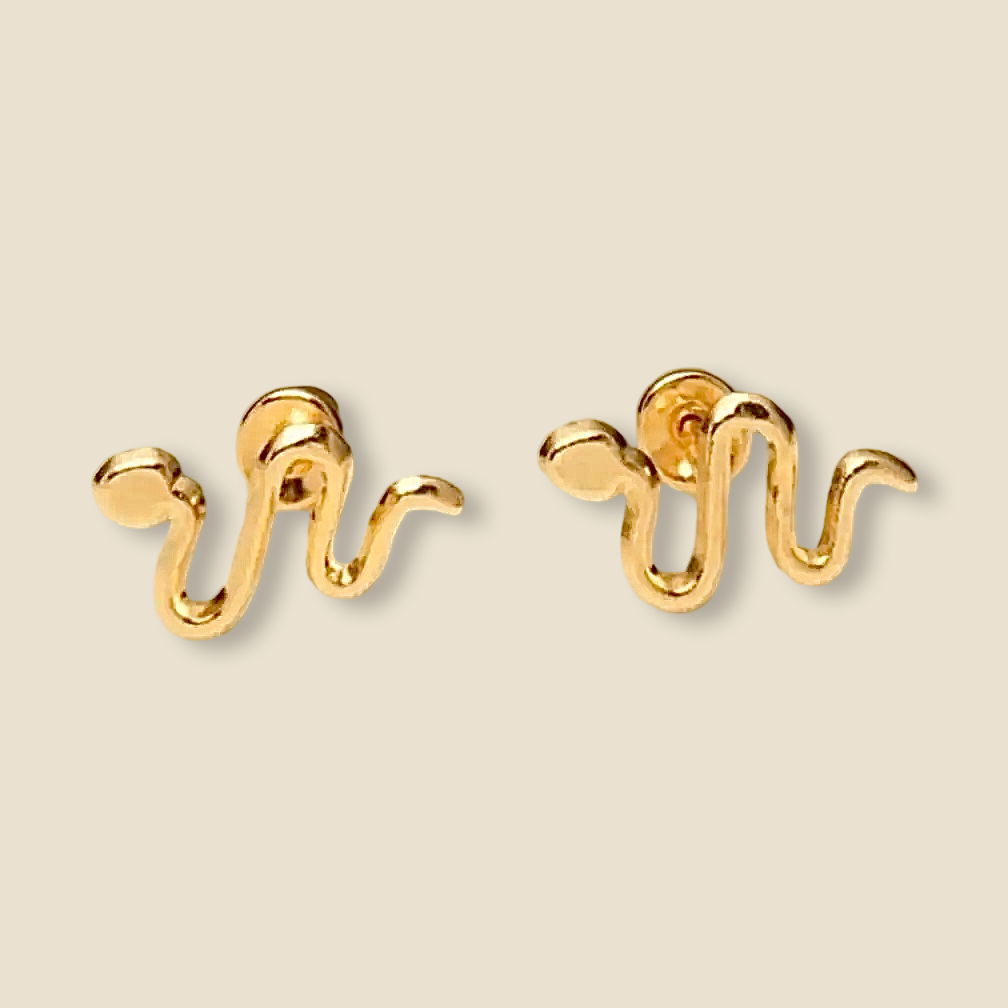 Close-up of 14K gold snake stud earrings on a plain background, showing polished texture and screw back detail.