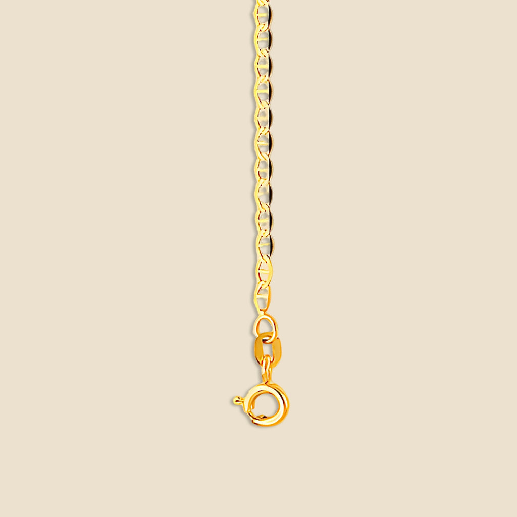 Close-up of 14K gold mariner chain necklace on a plain background, clearly showing the structure, length, and smooth polish of the solid gold links.