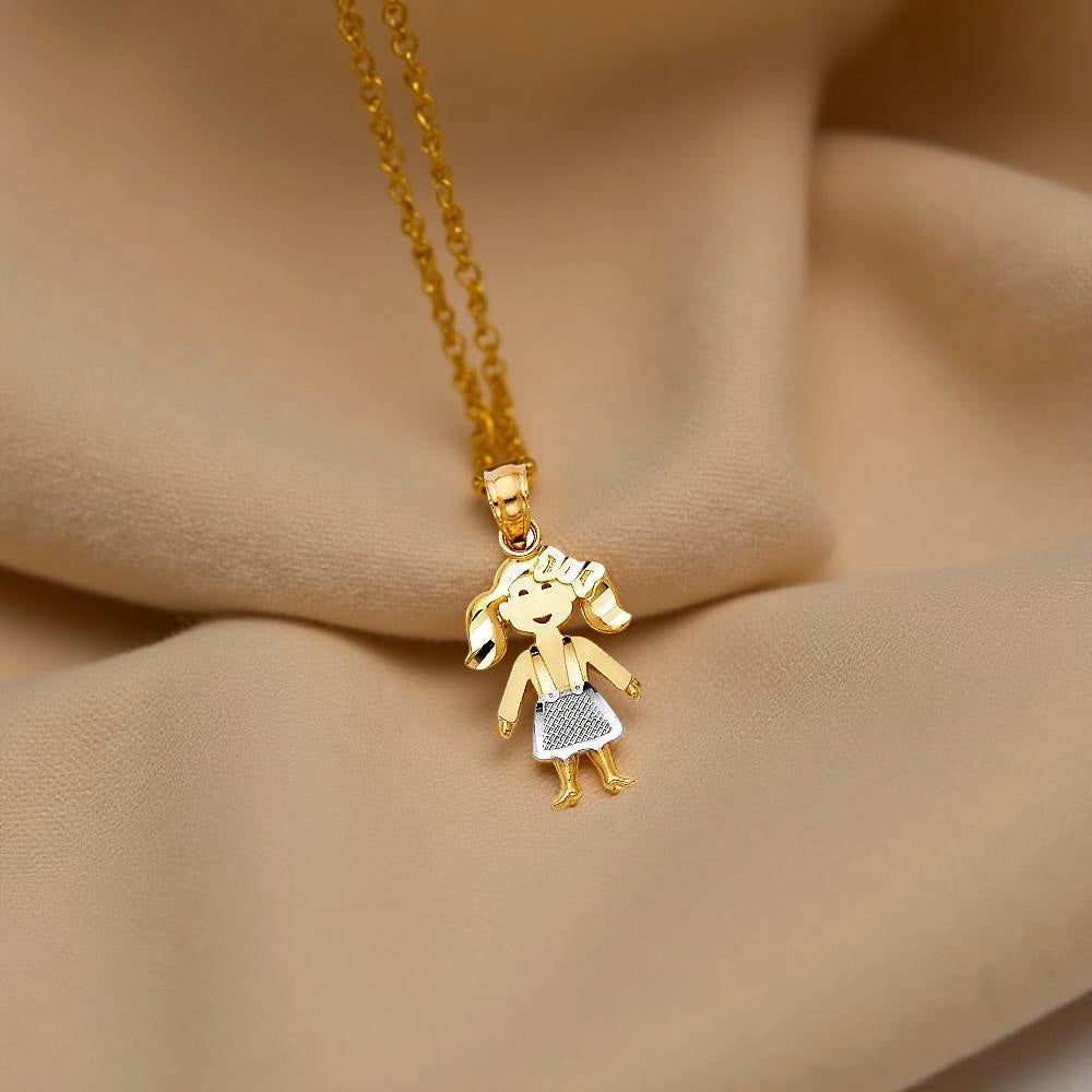 Close-up of a 14K two-tone gold baby girl pendant resting gently on textured off-beige cloth. The warm, soft fabric highlights the pendant's graceful details and radiant gold tones, evoking a sense of love and warmth.