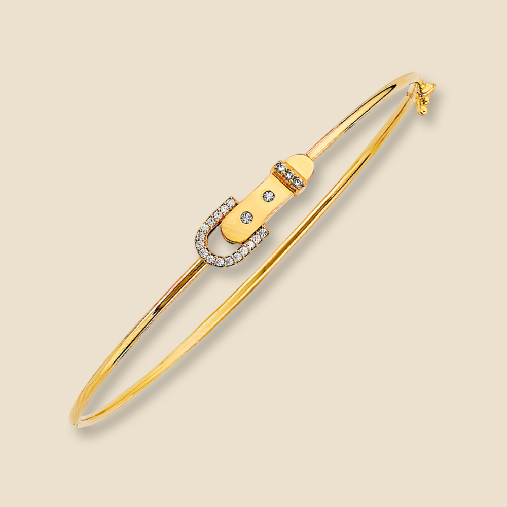 A 14K Yellow Gold CZ flexible bangle on a plain background, featuring a sleek, high-polish finish and delicate cubic zirconia accents.