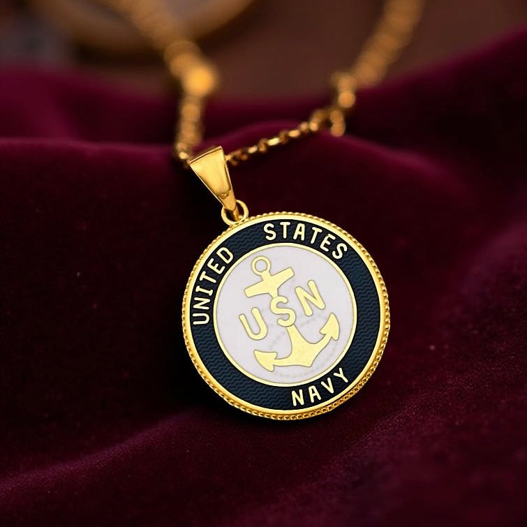 Elegant military charm placed on a burgundy velvet cloth background, emphasizing the shine of the yellow gold finish.