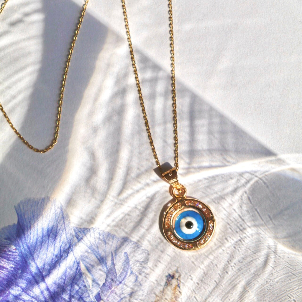 14K Yellow Gold Evil Eye Charm Pendant displayed against a plain background, showcasing its intricate detailing and polished finish.