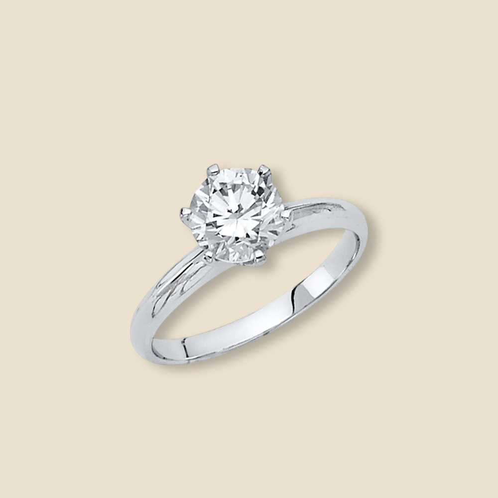Close-up of a 14K white gold CZ engagement ring on a plain background, highlighting the band’s dual-tone detail and sparkling stone.