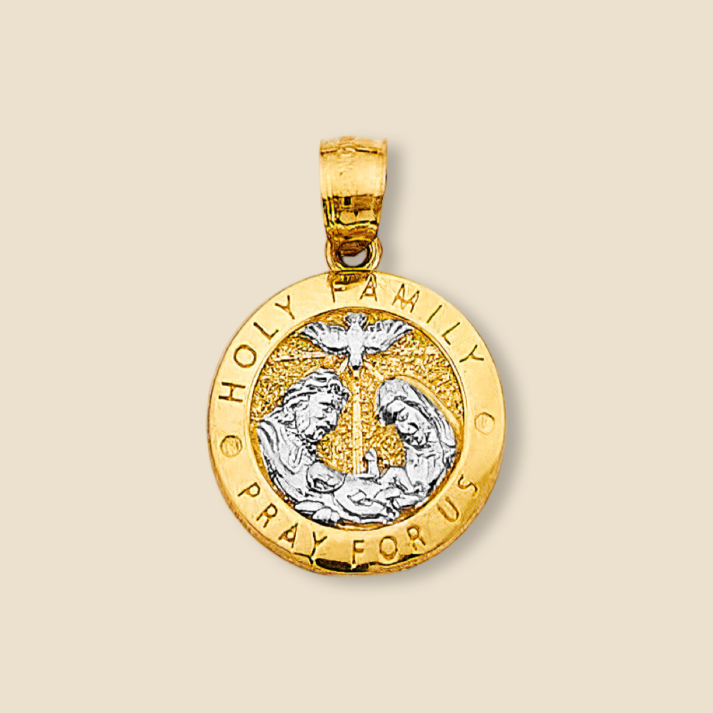 Studio photo of the 14K two-tone Holy Family pendant on a plain background, showcasing the medallion’s circular design and engraved sacred imagery.