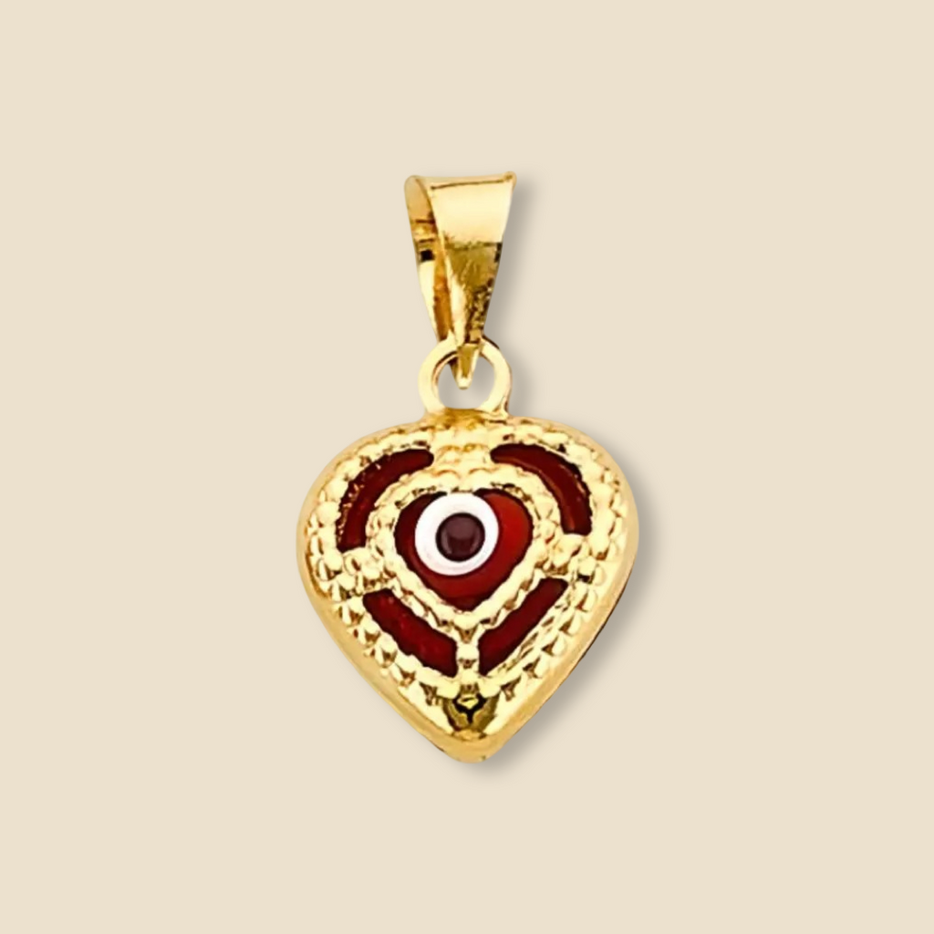 14K yellow gold heart-shaped evil eye pendant with red center displayed on a plain white background, highlighting its polished finish and fine detail.
