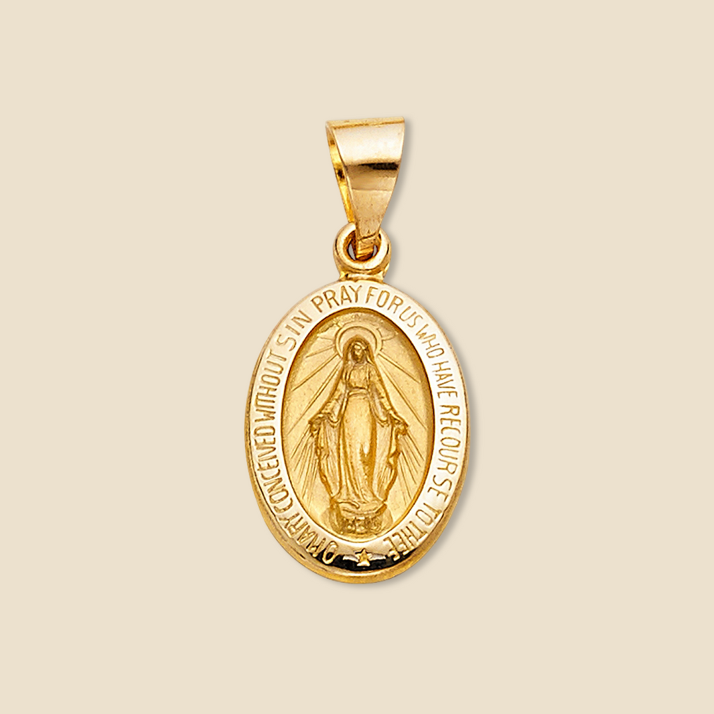 14K yellow gold Milagrosa pendant displayed against a plain background, showing its oval shape and religious detail with clarity and focus.