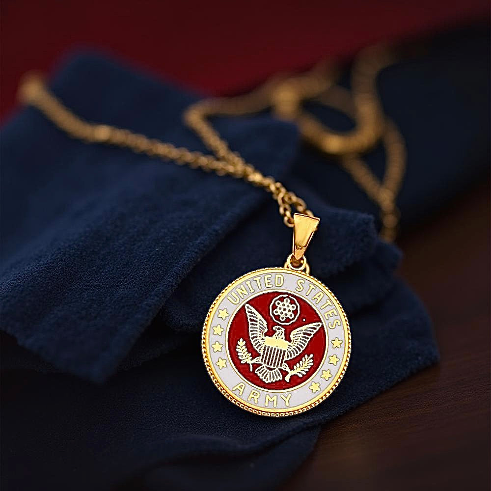 14K gold US Army pendant resting on a dark blue textured fabric, showcasing its detailed military emblem in a warm and elegant setting.