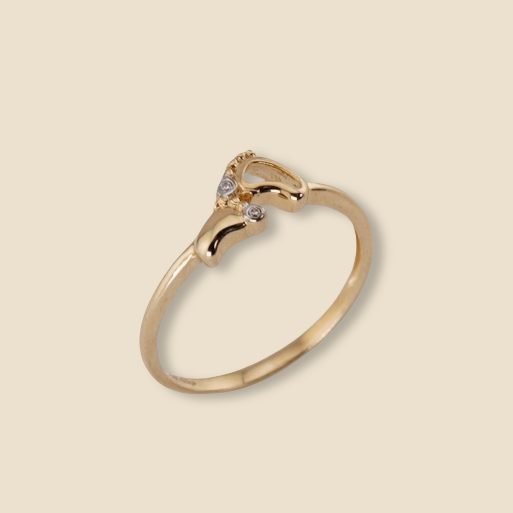 14K Solid Gold Baby Feet Ring displayed on a plain background, highlighting its polished finish and delicate design.