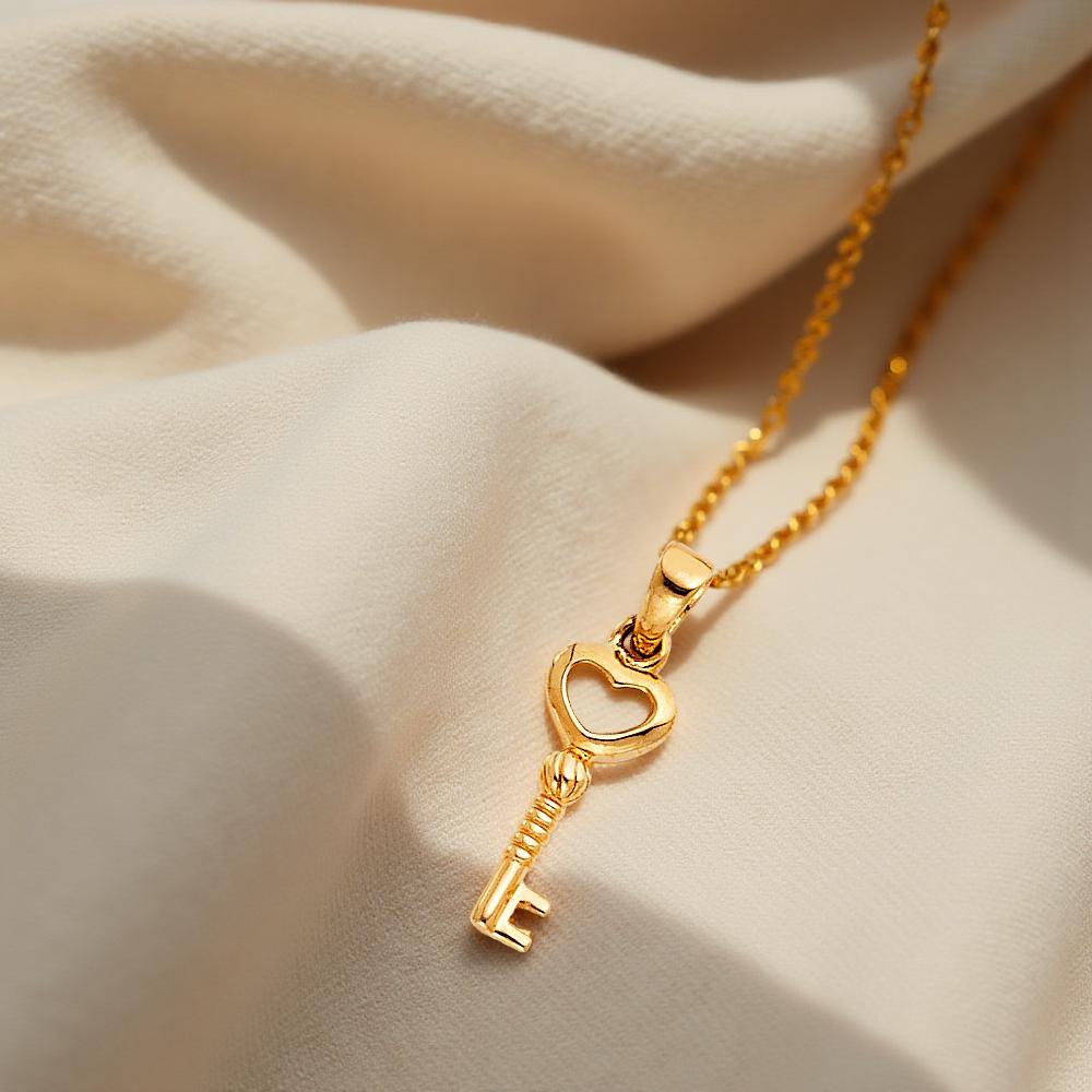 Minimalist 14K Gold key charm pendant resting on soft, textured off-white linen cloth, highlighting its small size and delicate design.