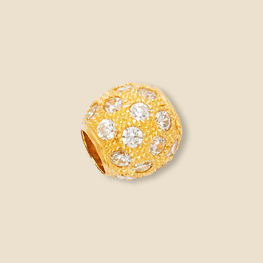 Large 10mm 14K yellow gold bead charm pendant featuring a diamond-cut pattern and dazzling cubic zirconia stones, beautifully displayed on a plain background to accentuate its bold and radiant shine.