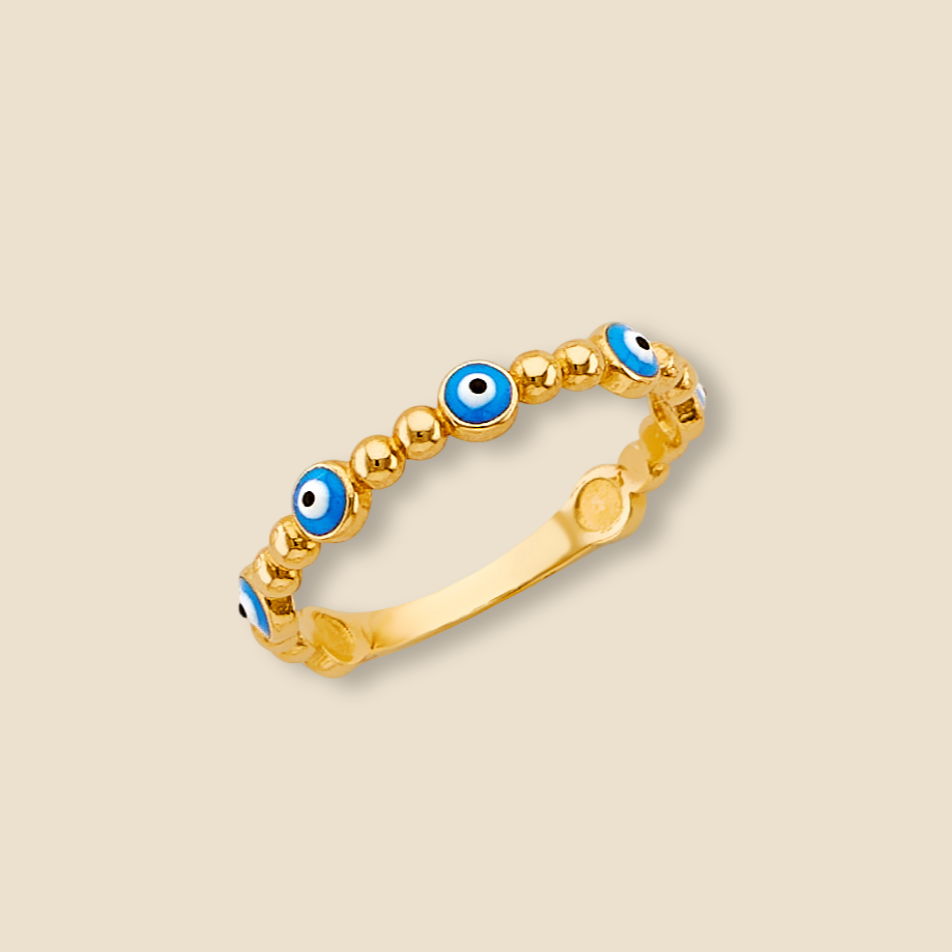 A minimalist 14K yellow gold evil eye ring with light blue enamel sits centered against a plain background, its smooth gold band and protective enamel eye design clearly visible, reflecting light to emphasize the charm’s elegant simplicity.