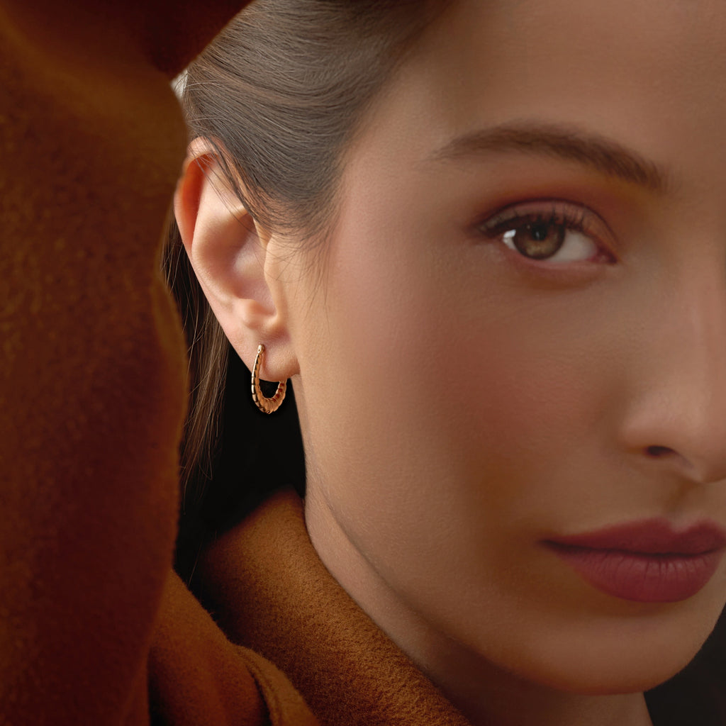 Model wearing 14K Yellow Gold Fancy Hollow Hoop Earrings, showing their elegant shine and comfortable lightweight design.