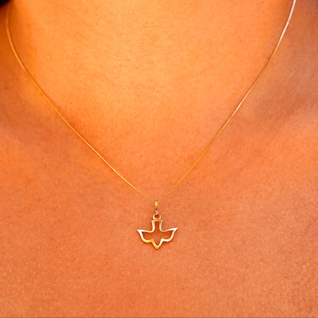 A model wearing the 14K solid gold Holy Spirit charm pendant on a delicate gold chain, showcasing the pendant's elegance and spiritual design as it rests gracefully on the model’s neck.
