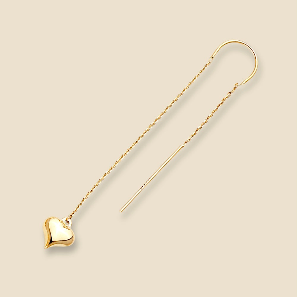 A single 14K gold heart dangle earring displayed on plain background, emphasizing its lightweight design, slim profile, and graceful curvature of the long, elegant gold lines.