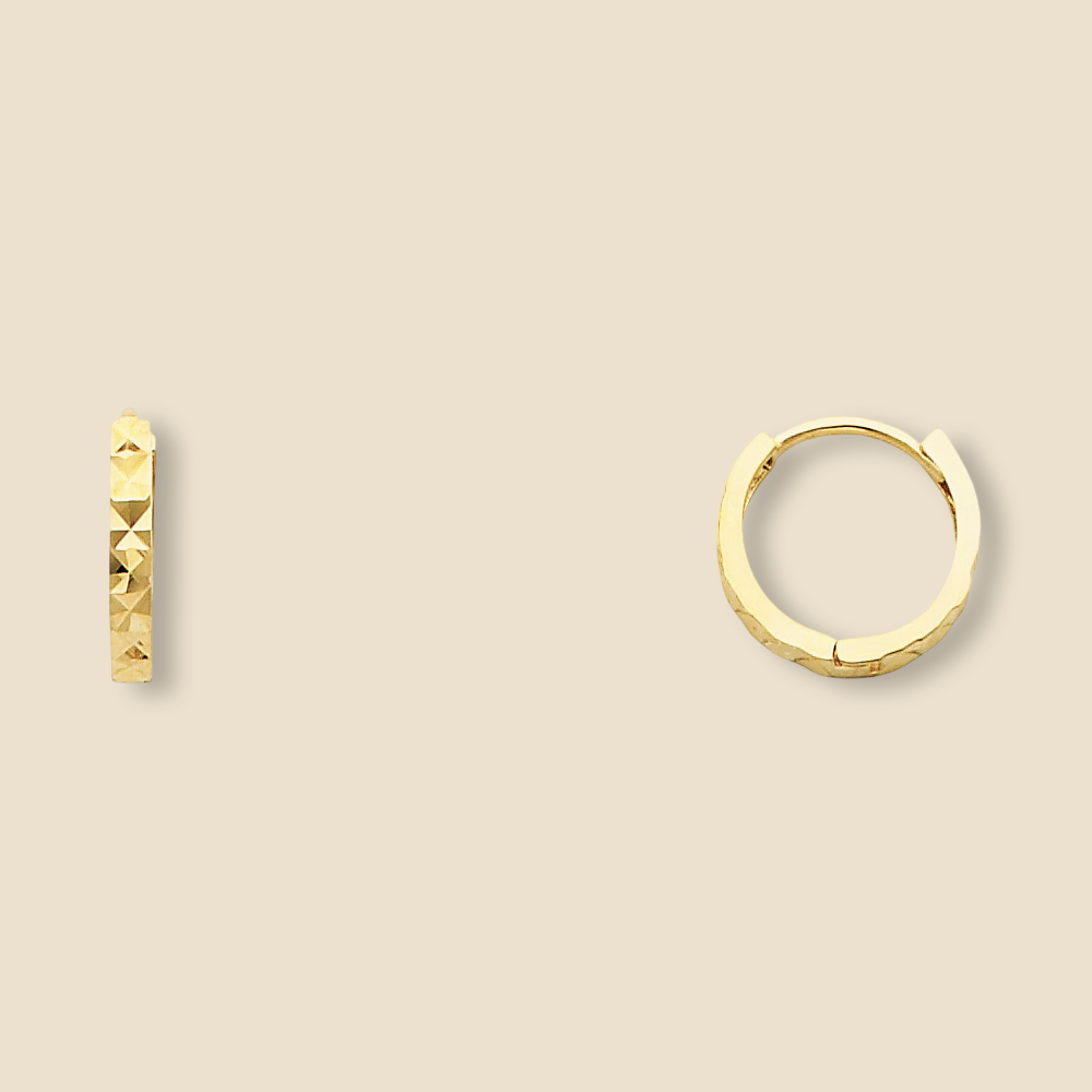 A pair of 14K yellow Gold Huggies earrings against a plain backdrop, clearly showing the 11mm round shape and diamond-cut design.