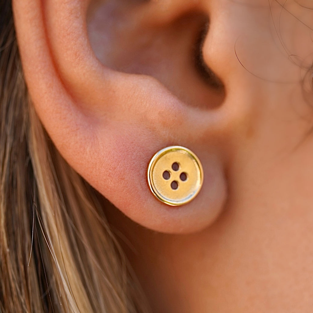 Model wearing 14K Yellow Gold Button Stud Earrings, showcasing the classic round shape and polished shine perfect for everyday wear.