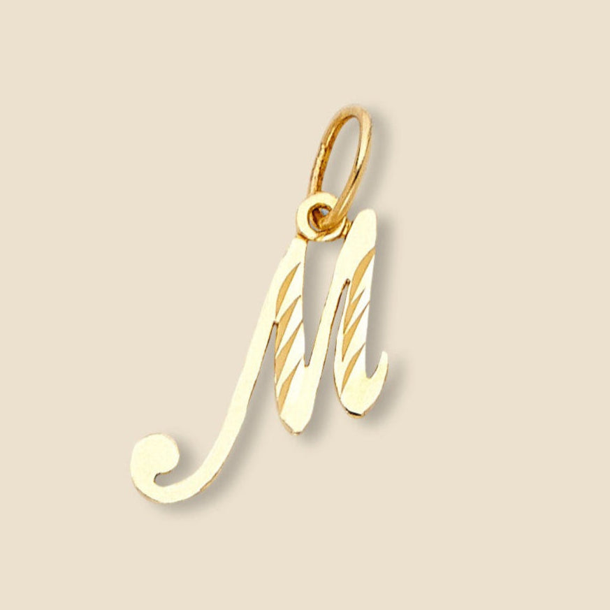  Solo view of a 14K gold M initial pendant on a plain background, emphasizing its minimalist and modern design.