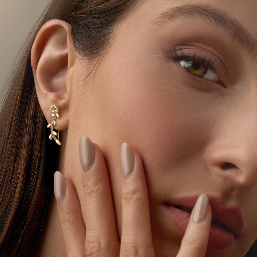 Model wearing 14K Yellow Gold Fancy CZ Drop Earrings, capturing their graceful drop design and subtle sparkle.