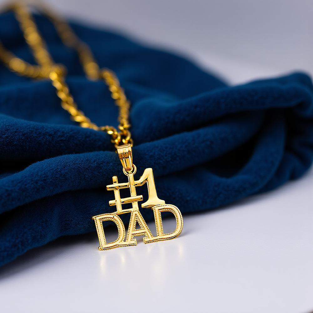 4K Yellow Gold #1 Dad Pendant resting on blue velvet fabric, showing polished gold and bold lettering.