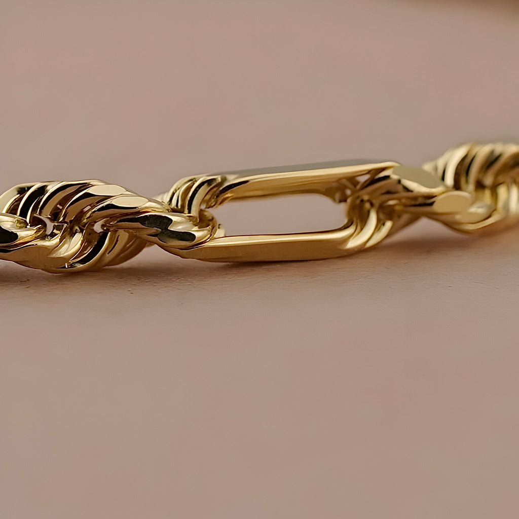 14K Yellow Gold 4mm Figaro Rope Chain Bracelet displayed on a clean background, highlighting the shine and texture of the gold links.