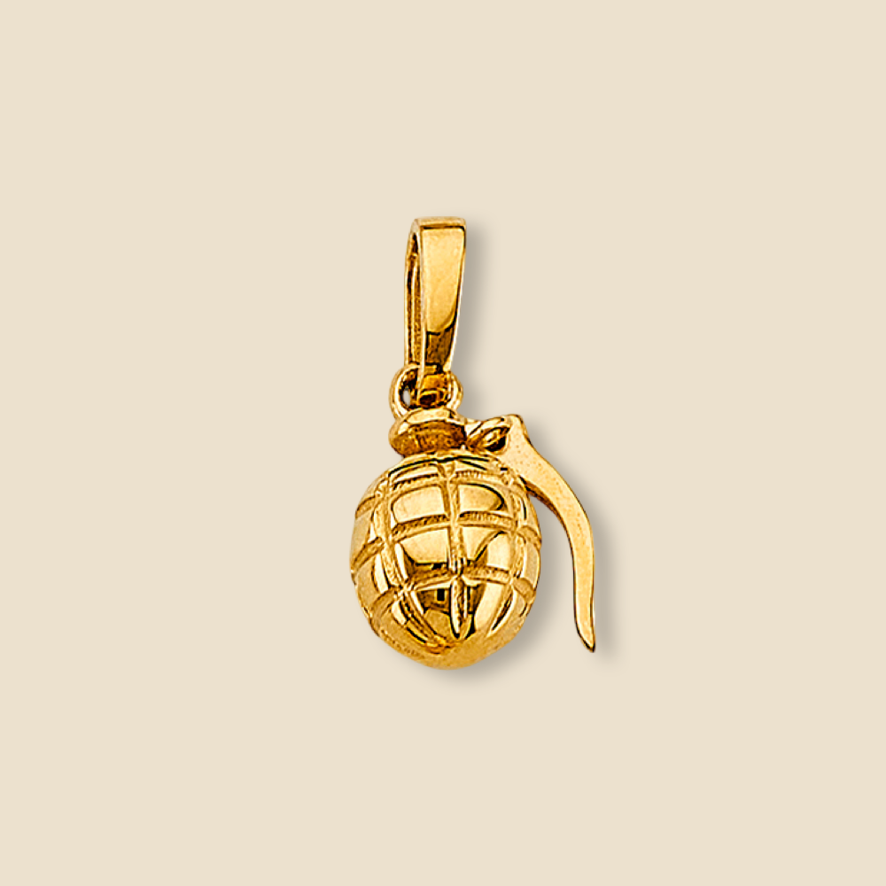 Close-up of 14K yellow gold grenade pendant isolated on a plain background, emphasizing its miniature size and solid design.
