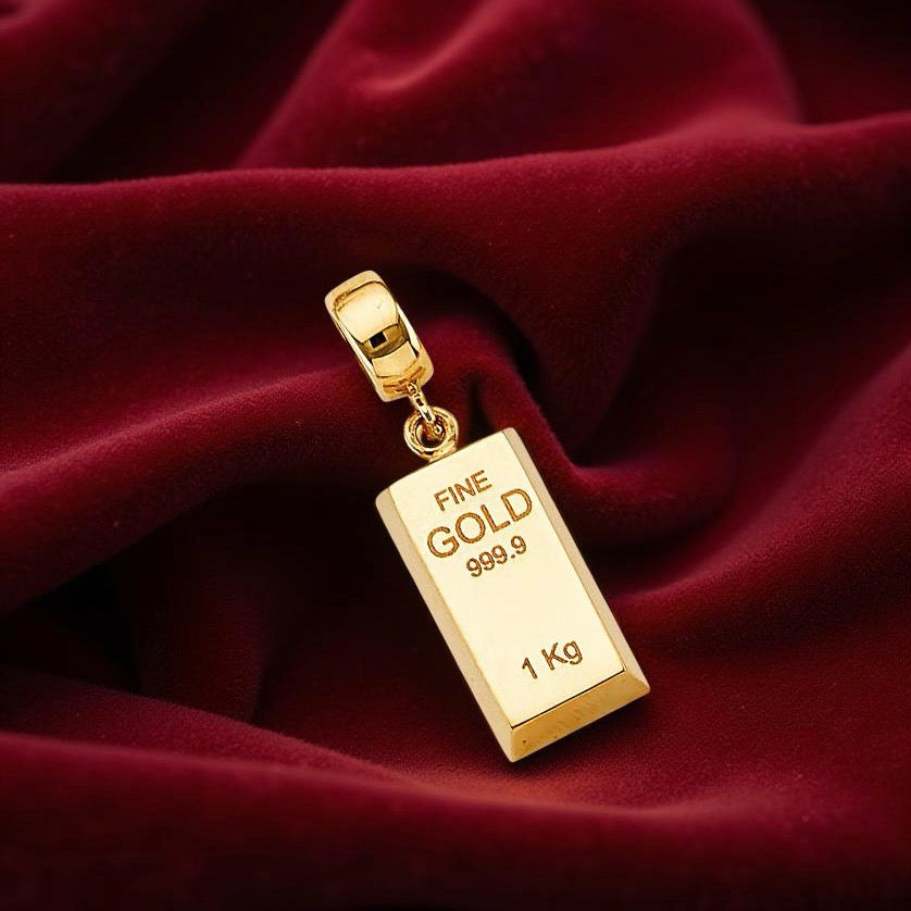 Elegant gold bar pendant displayed on red velvet fabric, emphasizing its bright yellow tone and refined proportions.