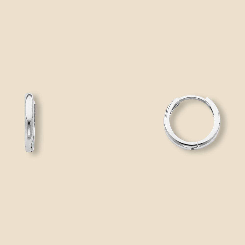 A pair of small 14K white gold Huggies earrings shown against a plain backdrop, revealing the sleek curvature and 10mm diameter of each hoop.