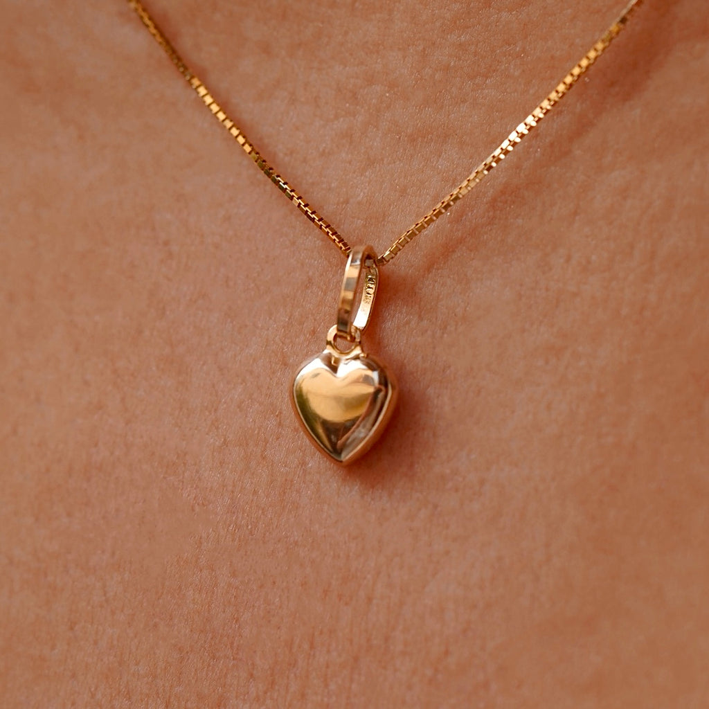 Dainty 14K Gold Hollow Heart Pendant worn by a model, gracefully resting on the collarbone, adding a touch of elegance to any outfit.