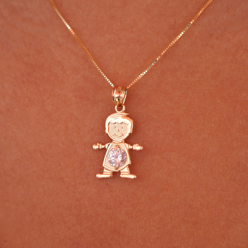 A model wearing the April boy charm on a delicate gold chain, showcasing how the dainty 14K gold pendant sits beautifully near the collarbone, with the white birthstone catching light elegantly.