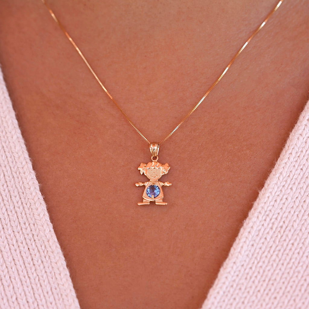A model wearing 14K solid gold girl charm pendant with March light blue birthstone on a necklace chain.