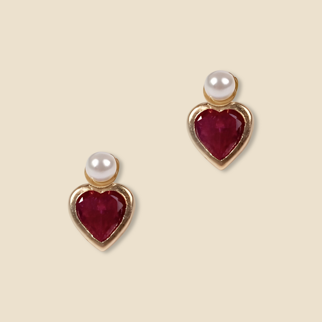 A close-up image of the 14K Gold Heart CZ & Pearl Earrings against a plain background, showcasing their delicate heart-shaped cubic zirconia and luminous pearl set in polished yellow gold.