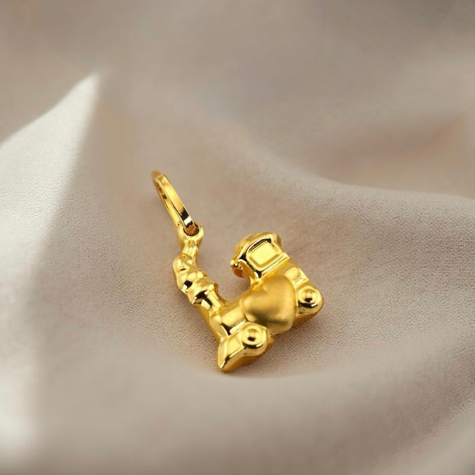 14K Gold Train of Love Charm showcased on a soft off-white linen fabric, capturing its detailed craftsmanship and warm yellow gold tone.