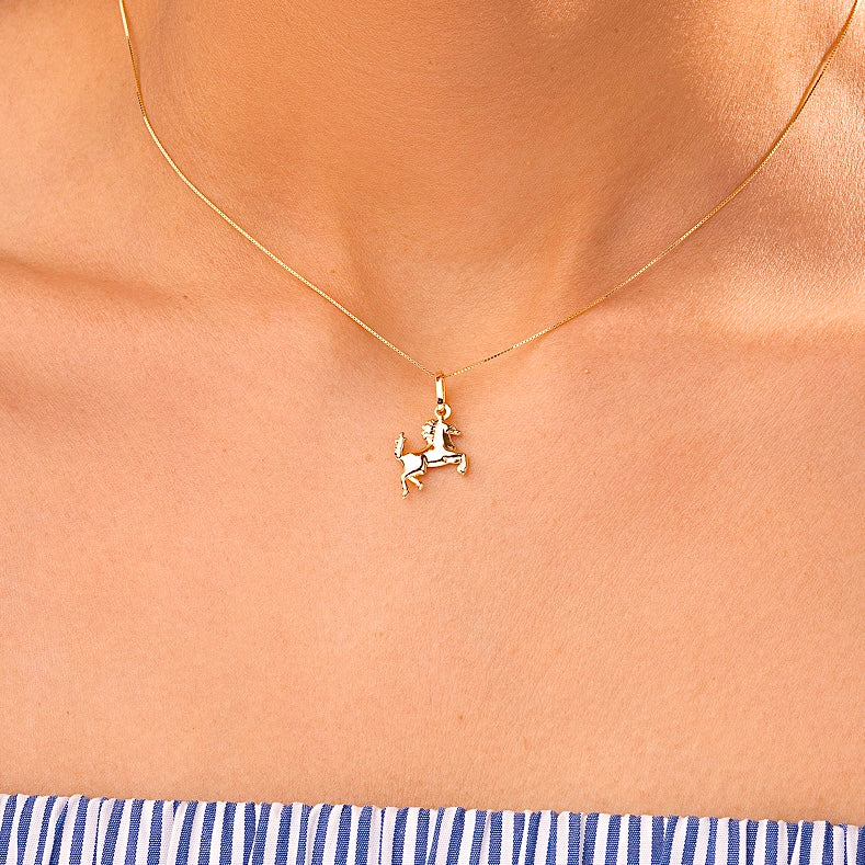 A model wearing the 14K Gold Horse Charm on a delicate chain, highlighting its elegance and versatility for everyday wear.