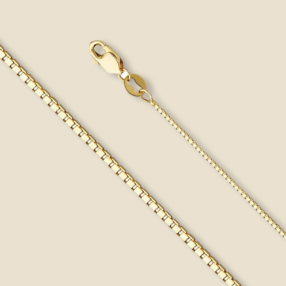 Studio image of a 14K gold box chain in yellow, laid straight on a plain background to emphasize its sleek 0.8mm design.