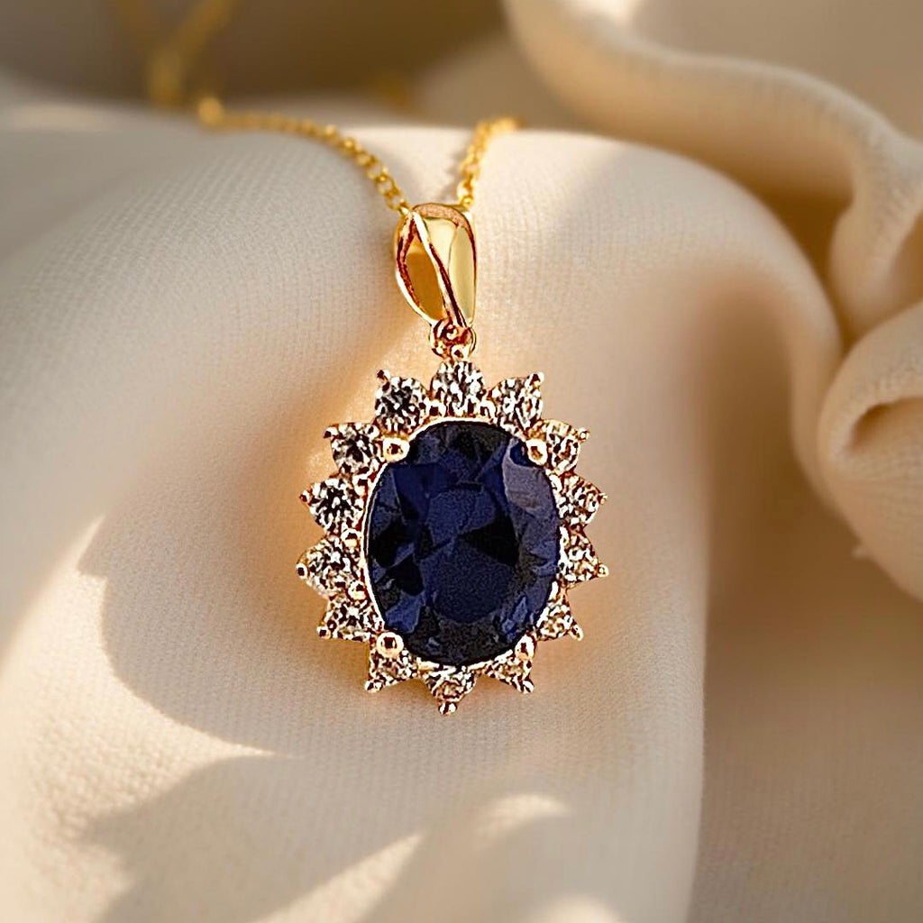 14K Yellow Gold Pendant displayed on a textured, off-white linen cloth, highlighting its polished shine and intricate front detailing.