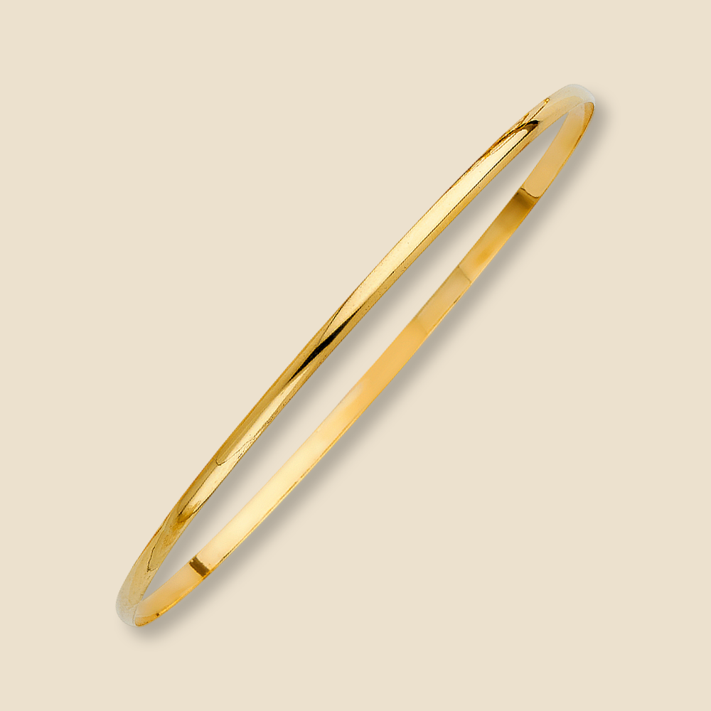 4K solid gold bangle against a plain background, emphasizing its clean and minimal design.