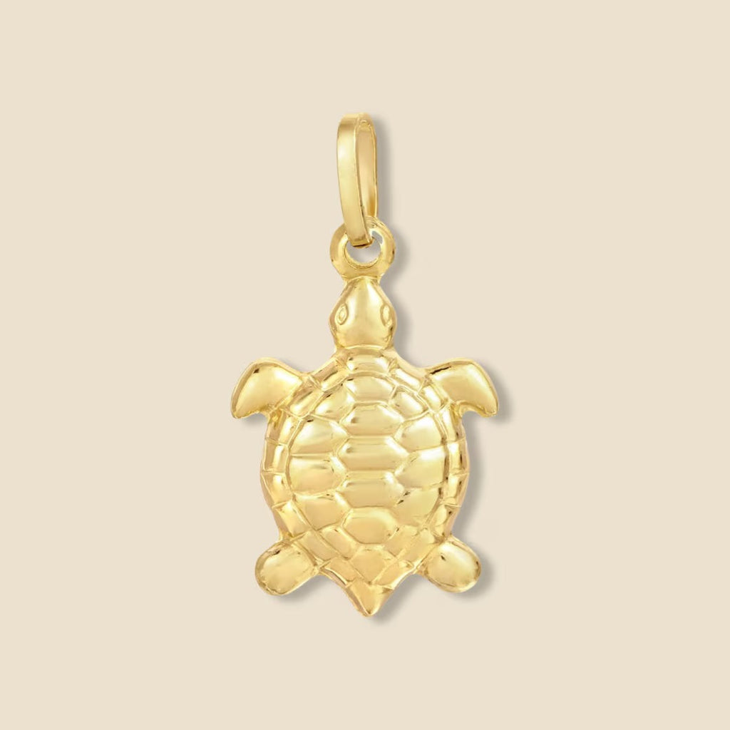 Close-up of 14K yellow gold turtle pendant on a plain background, showing its polished finish and intricate shell detailing.