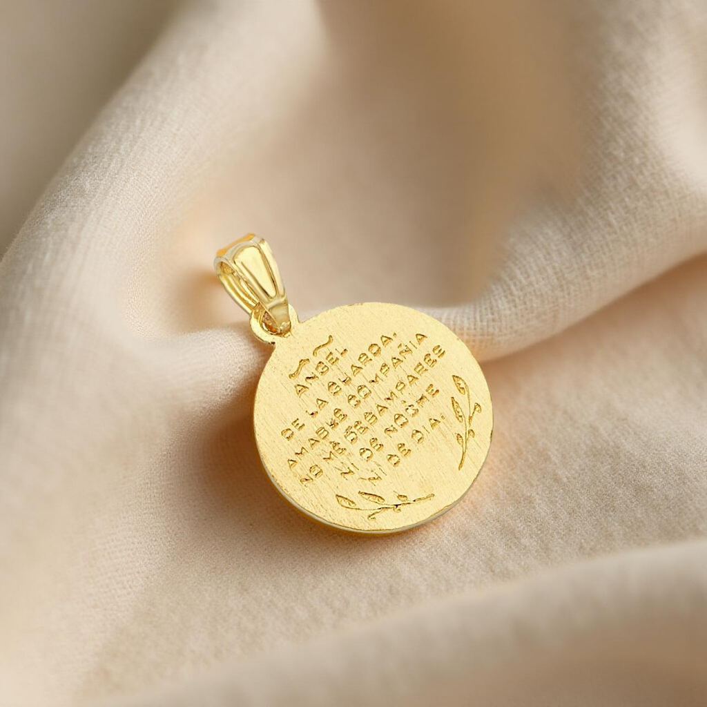 Back side of a 14K gold angel medallion pendant displayed on a textured off-white linen cloth, showcasing its smooth polished surface and fine craftsmanship.