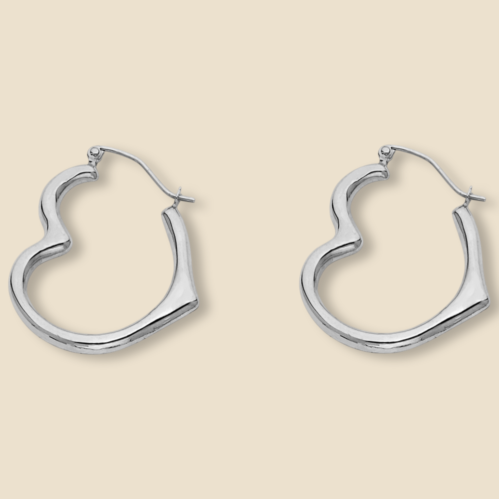 Close-up of minimalist 14K white gold heart-shaped hoop earrings, showcasing their polished finish and delicate design, set against a plain white background.