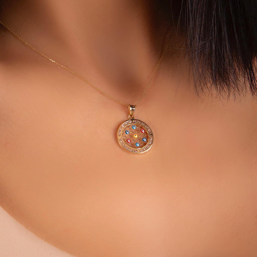 Model wearing the 14K Solid Gold Evil Eye Pendant on a delicate gold chain, showcasing its elegant shine and minimalist design against the skin.